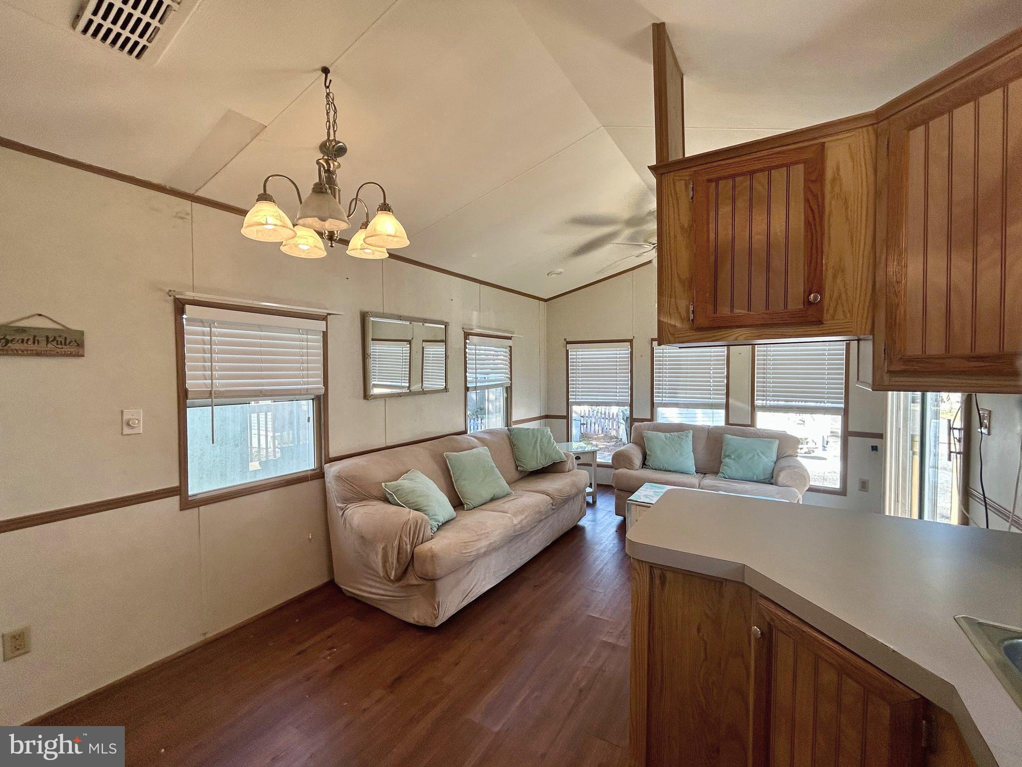 104 South 5th Avenue, Unit 39 Rio Grande, NJ 08242 - Photo 10 of 20 a living room with furniture and a chandelier