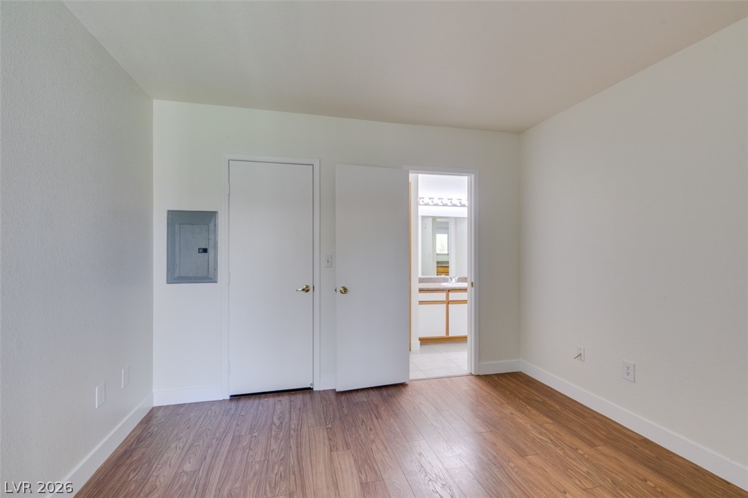 6650 West Warm Springs Road, Unit 2118 Las Vegas, NV 89118 - Photo 16 of 41 Rich hardwood-style flooring extends into this spacious room with convenient bathroom access.