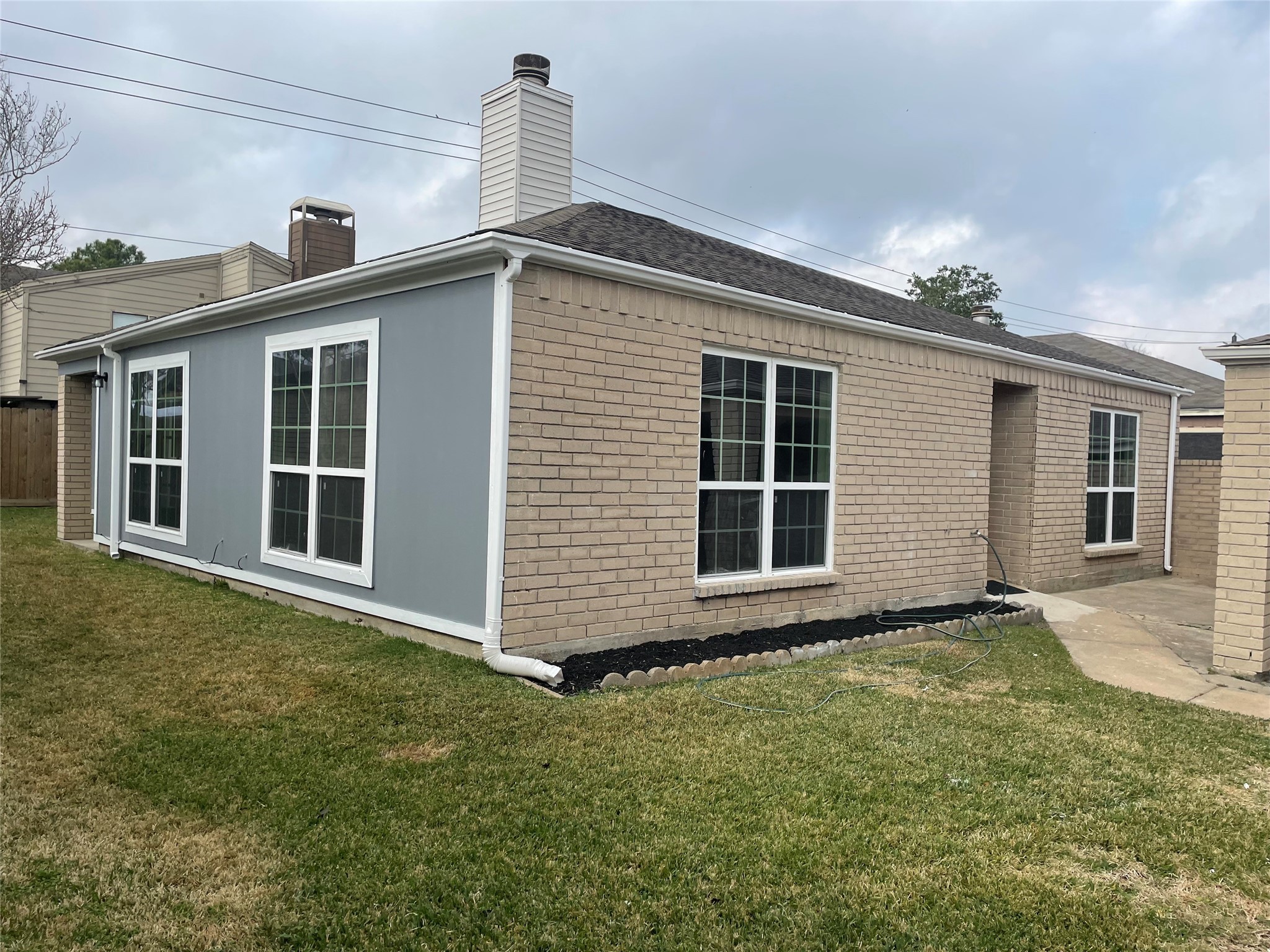 11630 Coachfield Lane Houston, TX 77035 - Photo 2 of 18 a front view of a house with a garden