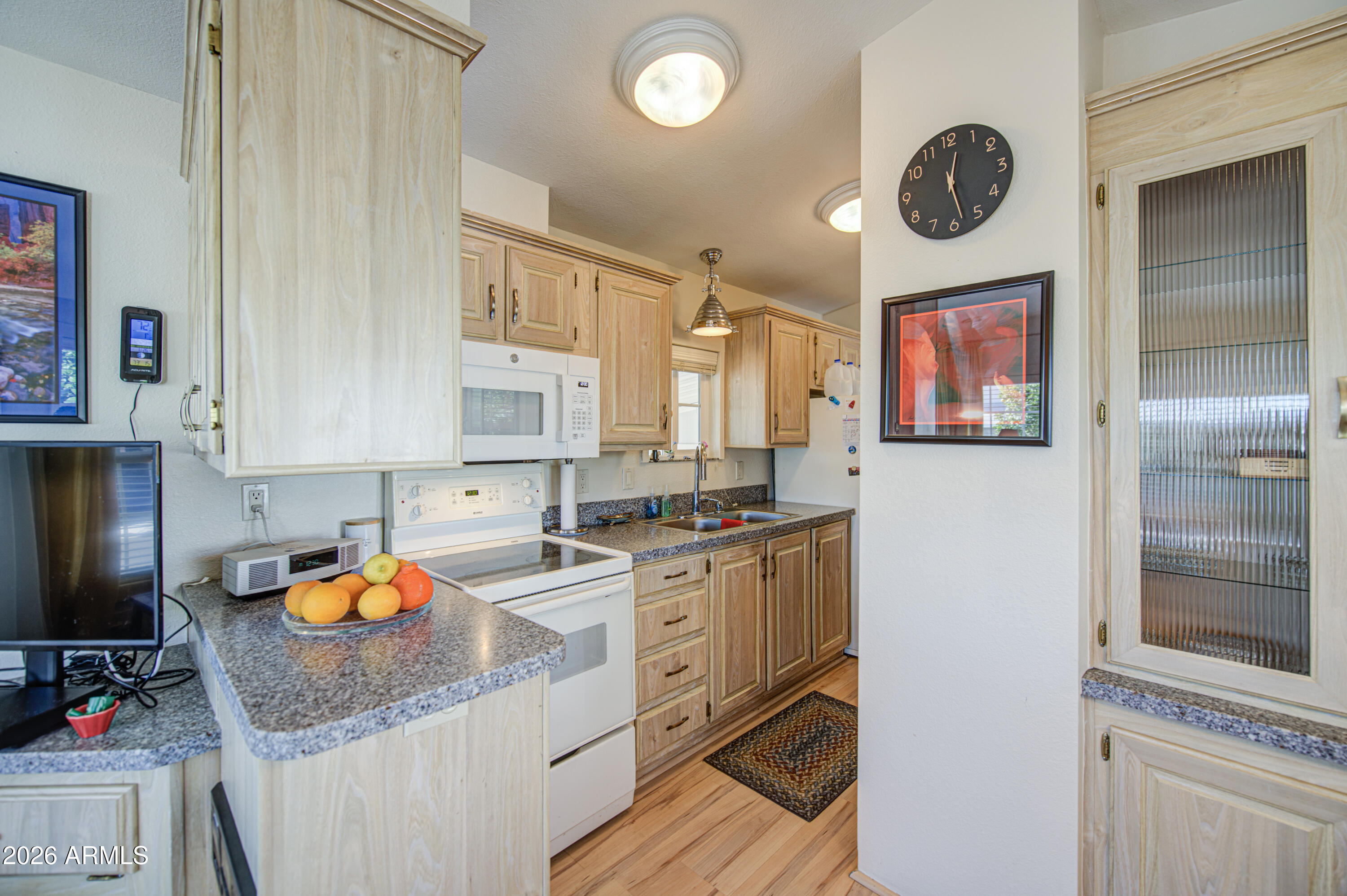 7750 East Broadway Road, Unit 314 Mesa, AZ 85208 - Photo 2 of 32 a kitchen with stainless steel appliances granite countertop a stove a sink and a refrigerator