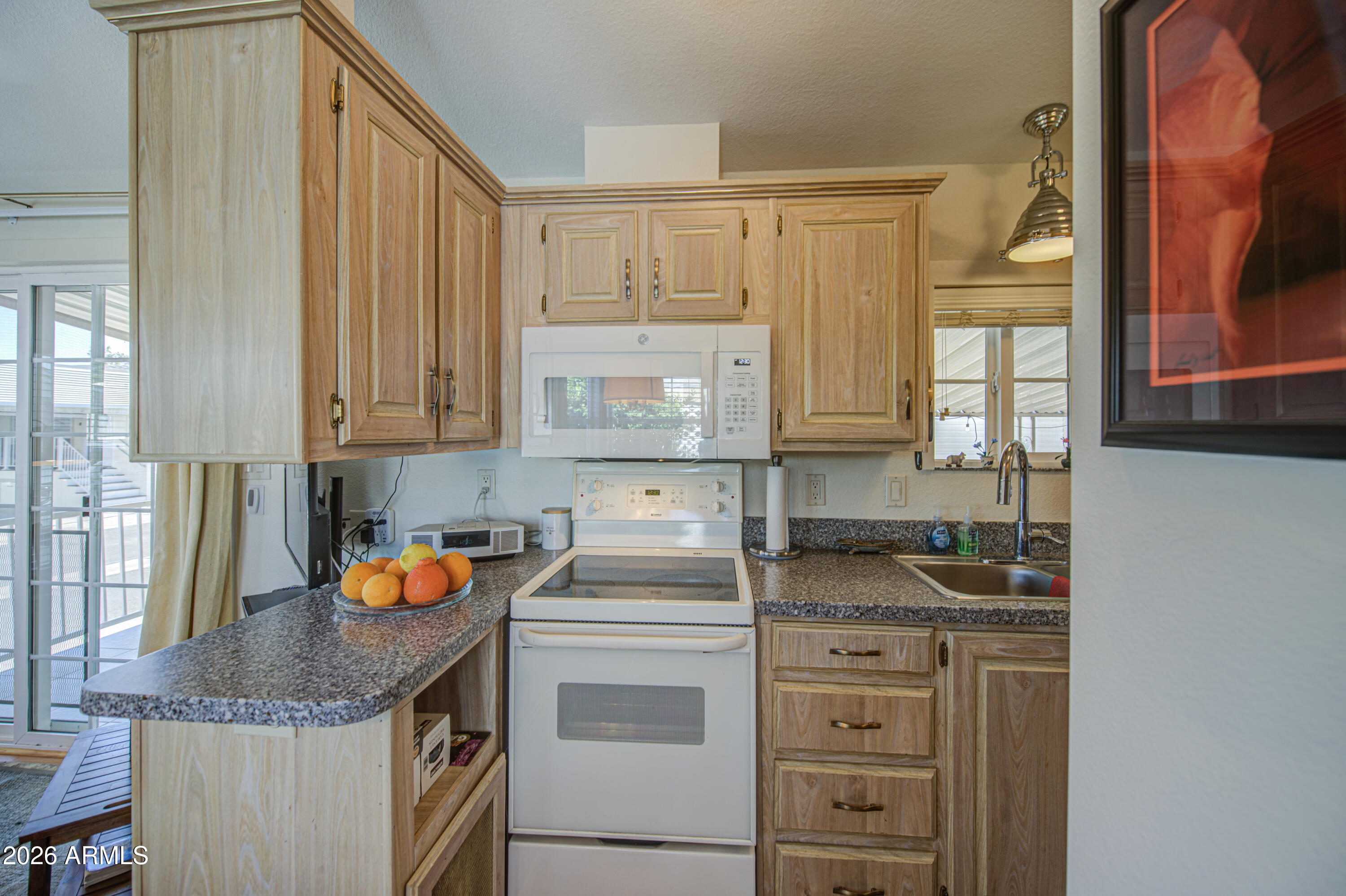 7750 East Broadway Road, Unit 314 Mesa, AZ 85208 - Photo 7 of 32 a kitchen with stainless steel appliances granite countertop a sink stove and cabinets
