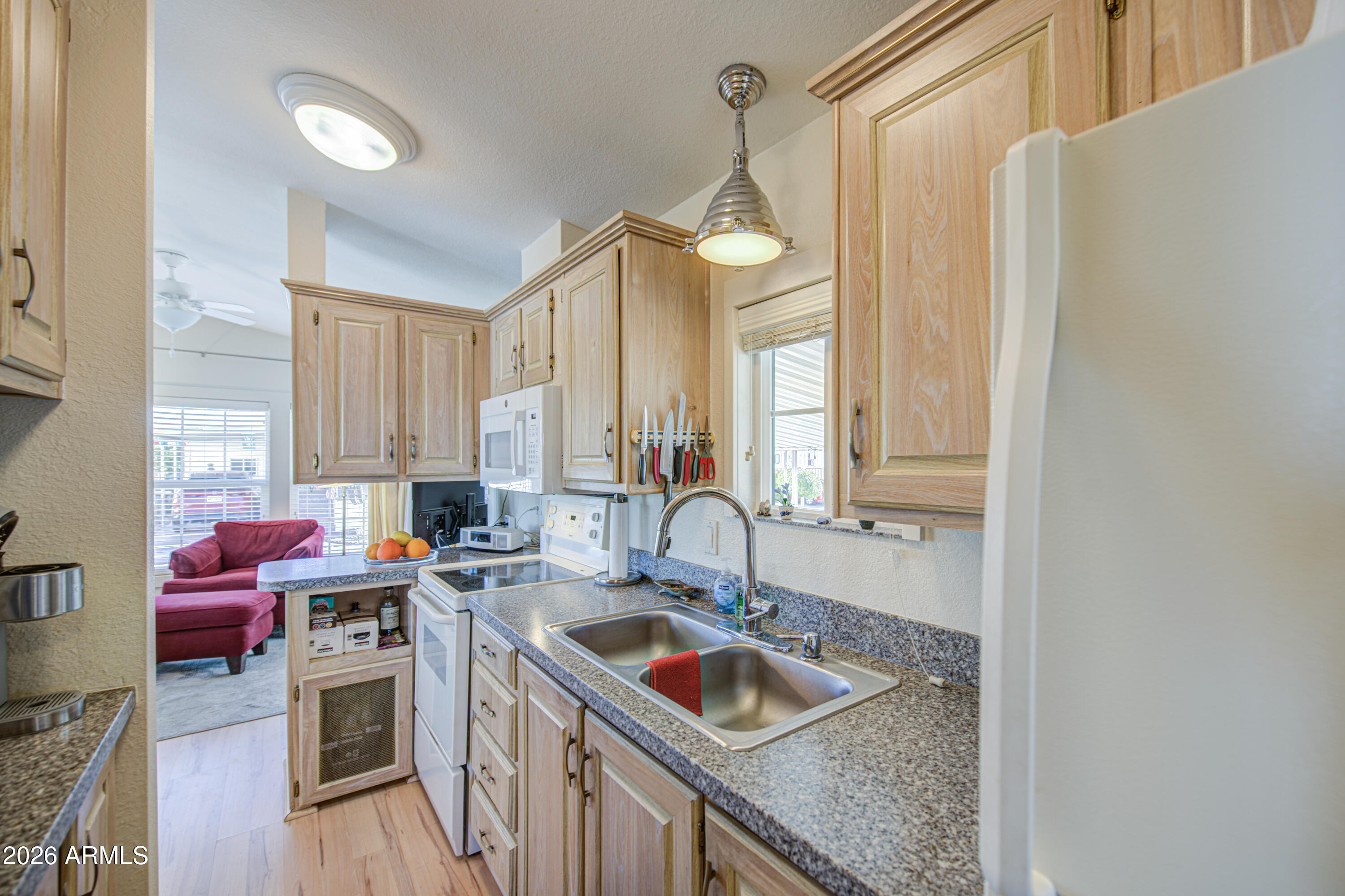 7750 East Broadway Road, Unit 314 Mesa, AZ 85208 - Photo 8 of 32 a kitchen with stainless steel appliances granite countertop a sink stove and cabinets