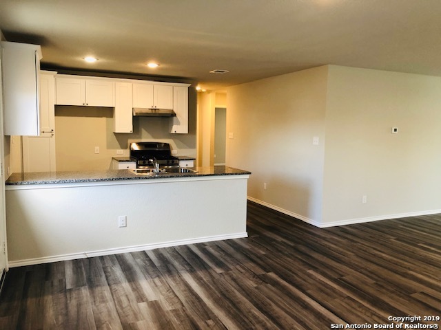 9015 Little Hoss Converse, TX 78109 - Photo 4 of 17 a kitchen with wooden floor and a sink