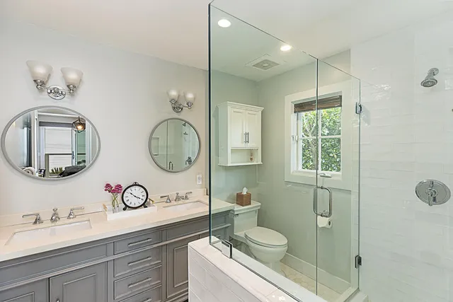 a bathroom with a toilet a sink and mirror