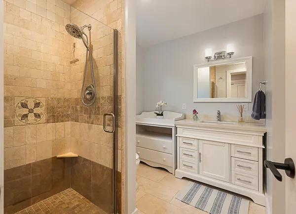a bathroom with a shower sink and mirror