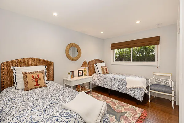 a bedroom with two beds and a window