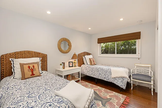 a bedroom with two beds and a window