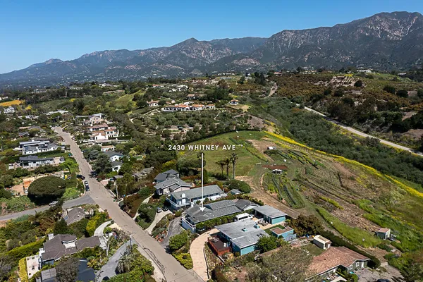 an aerial view of residential house and sandy dunes