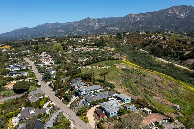 an aerial view of residential house and sandy dunes