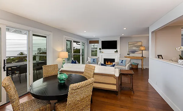 a living room with fireplace furniture and a wooden floor
