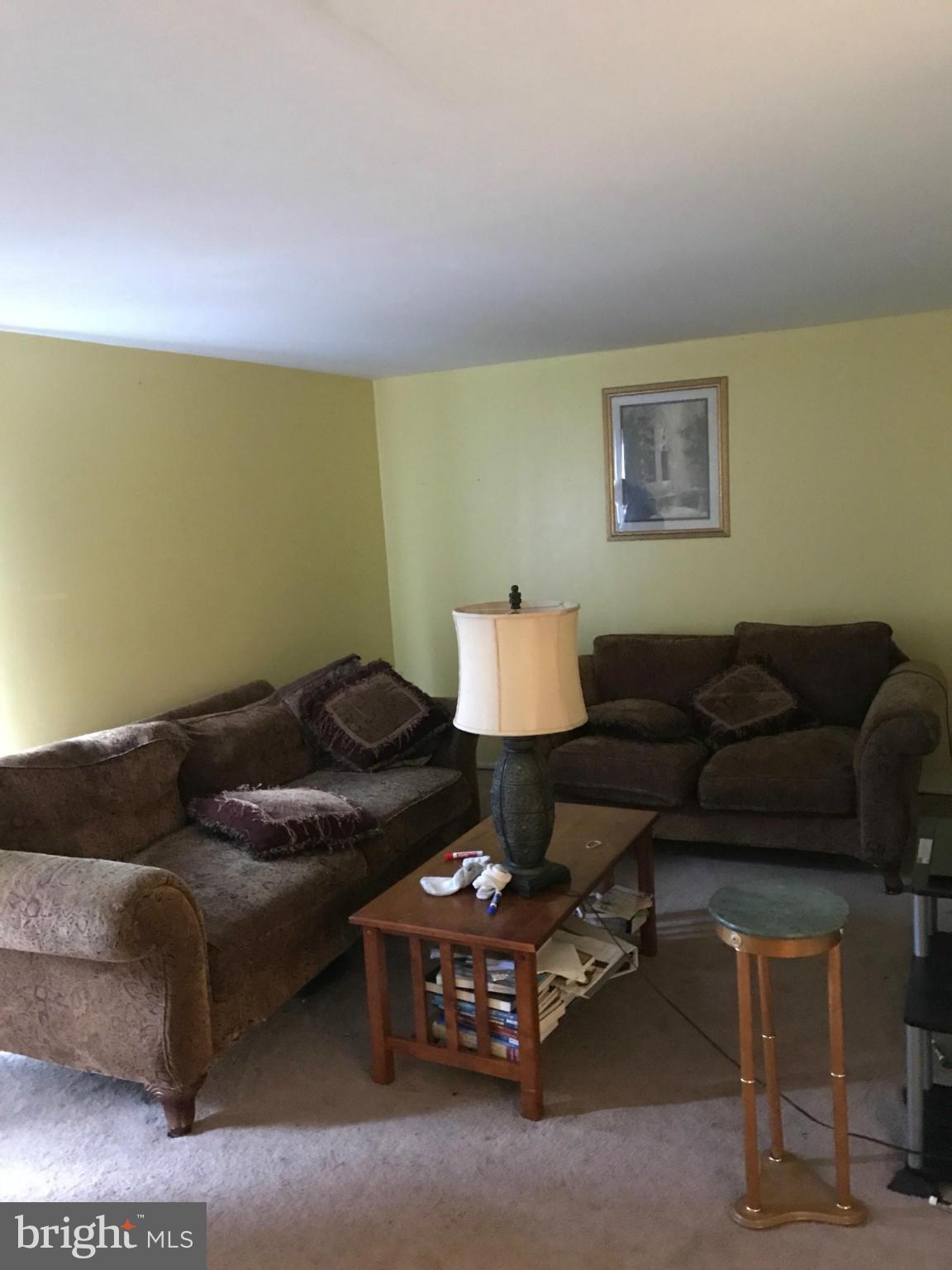 17642 Kohlhoss Road Poolesville, MD 20837 - Photo 2 of 3 a living room with furniture and a lamp