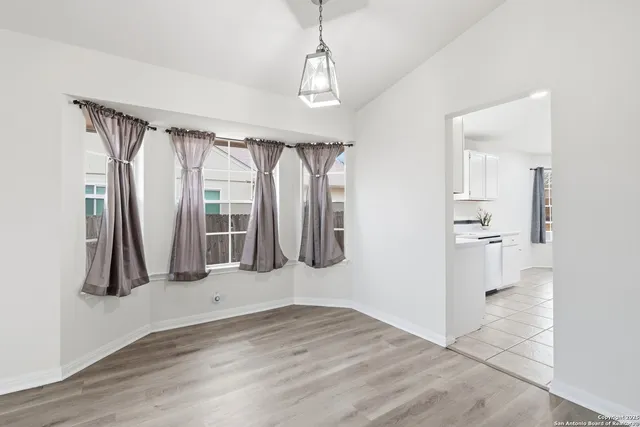 a bathroom with a double vanity sink mirror and bathtub