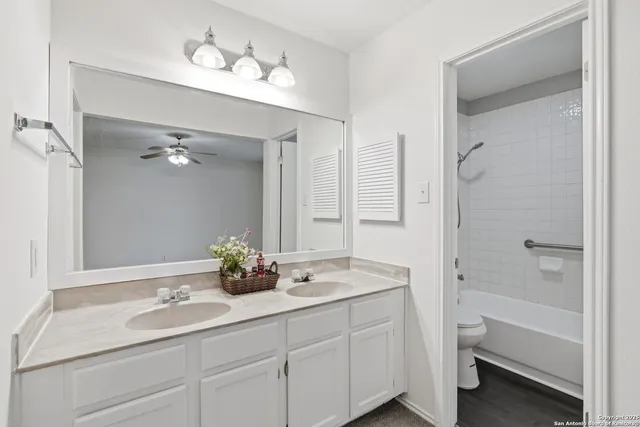 a view of a livingroom with a ceiling fan and window