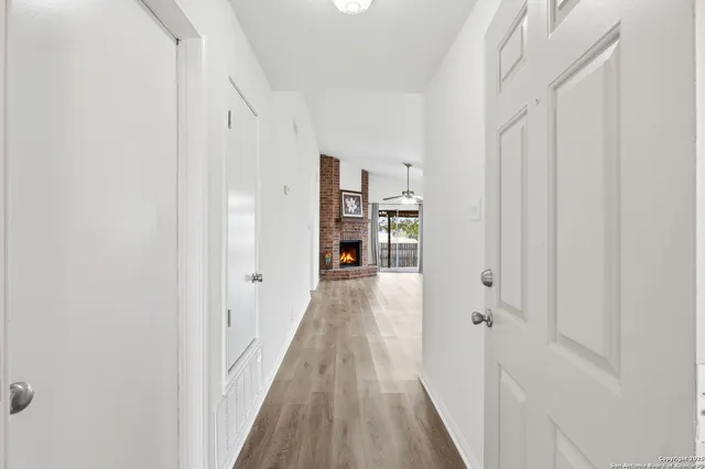 a view of a hallway with wooden floor and staircase