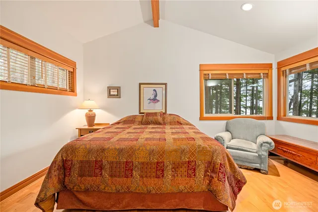 a bed sitting in a bedroom next to a window