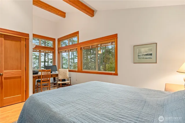 a bedroom with a large bed and a large window