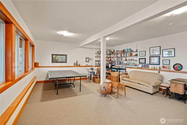 a living room with furniture a table and a large window