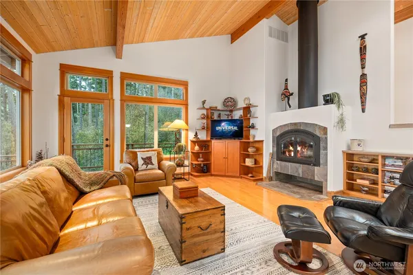 a living room with furniture a fireplace and a flat screen tv