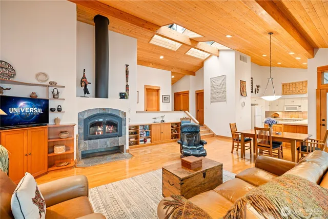 a living room with furniture fireplace and a table