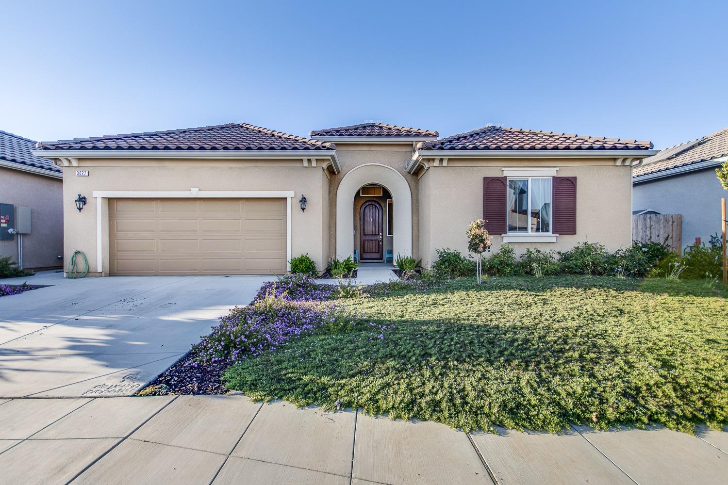3027 Twain Avenue Clovis, CA 93619 - Photo 1 of 32 a front view of a house with garden
