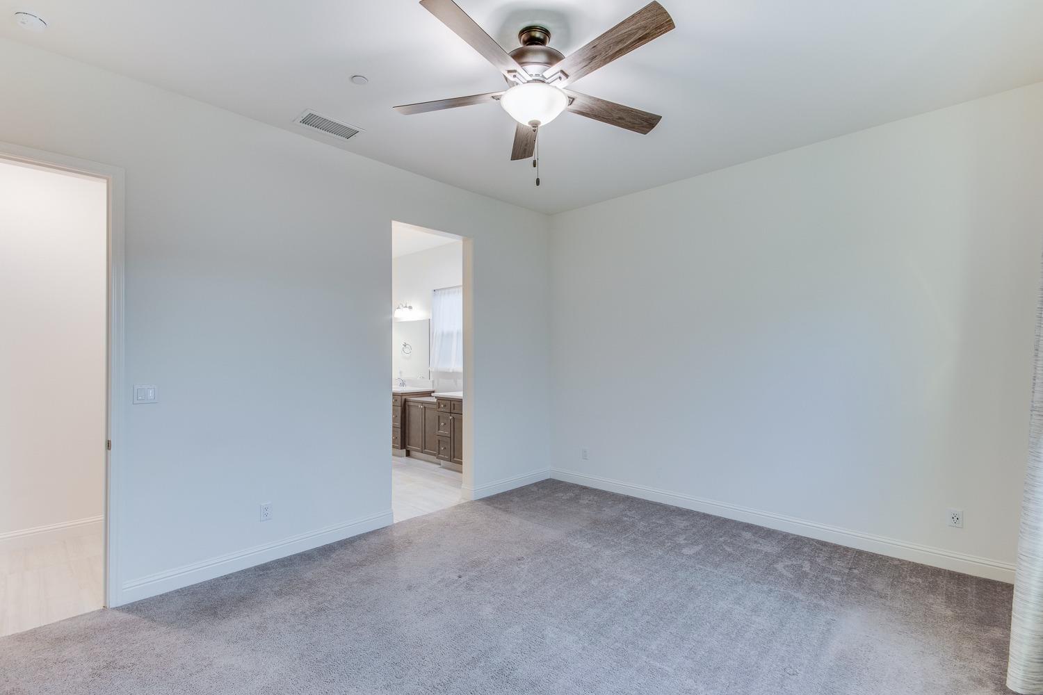 3027 Twain Avenue Clovis, CA 93619 - Photo 20 of 32 an empty room with a ceiling fan and a window