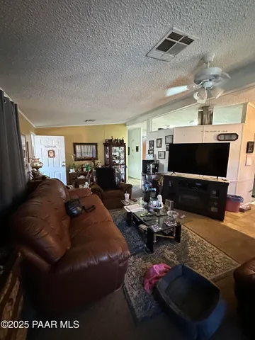 a view of a house with swimming pool and furniture