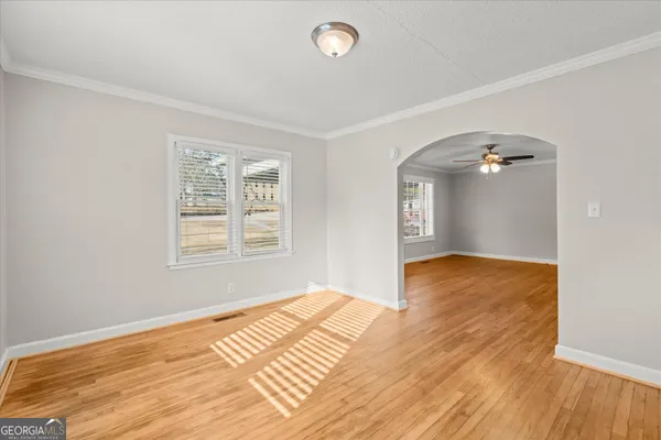 a view of empty room with wooden floor