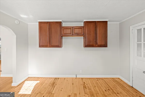 a view of room with window and wooden floor