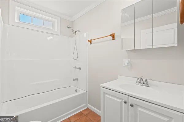 a bathroom with a sink a shower and vanity