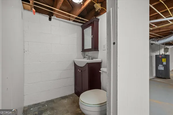 a bathroom with a toilet a sink and shower