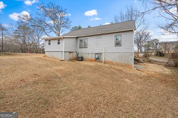 a view of a house with a yard covered in snow