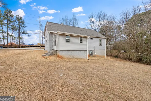 a view of a house with a yard and garage