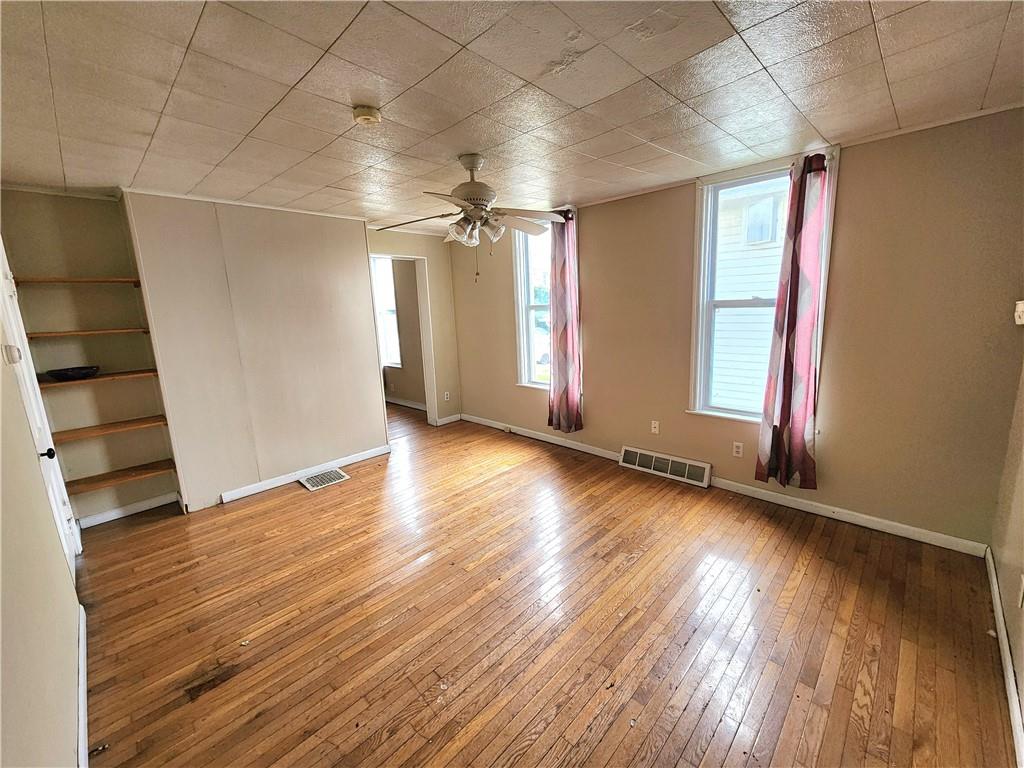 26 West Terrace Avenue New Castle, PA 16102 - Photo 8 of 12 an empty room with wooden floor and windows