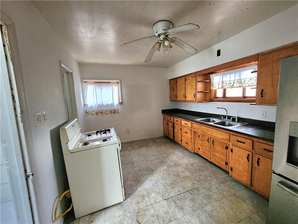26 West Terrace Avenue New Castle, PA 16102 - Photo 9 of 12 a kitchen with stainless steel appliances granite countertop a stove a sink and a refrigerator