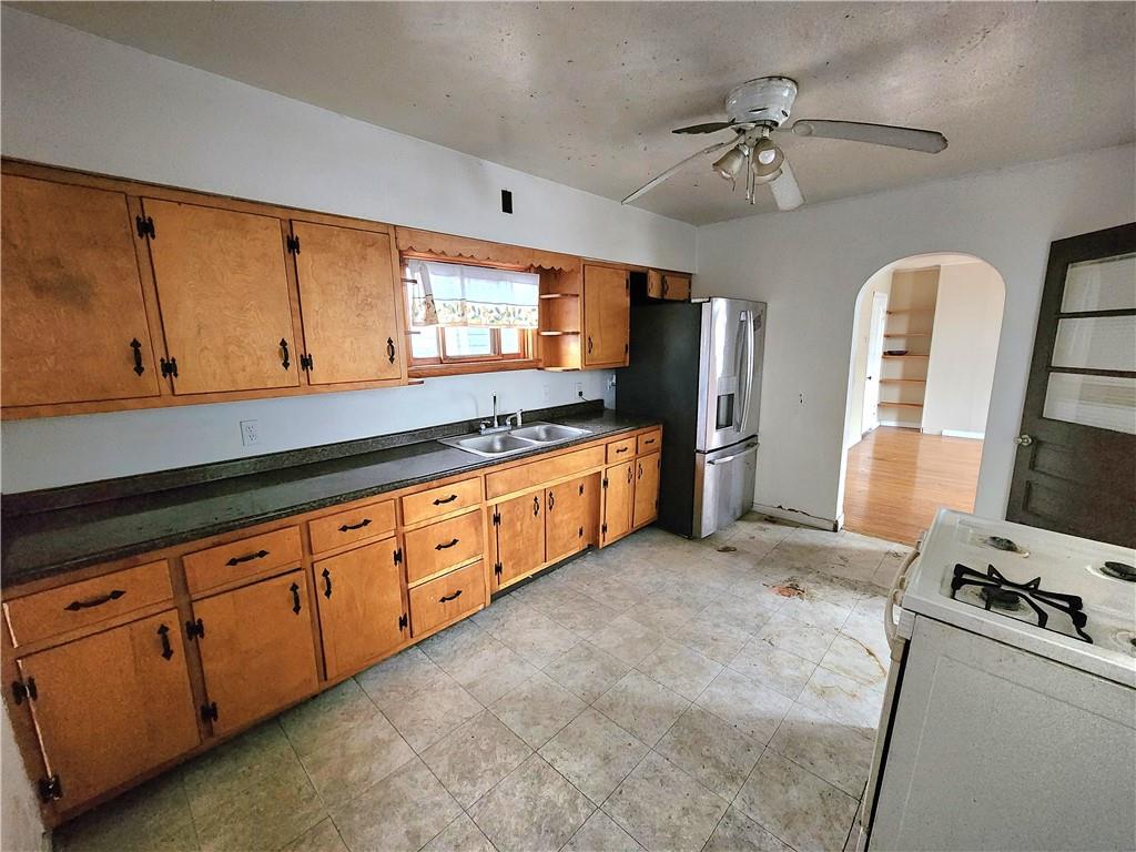 26 West Terrace Avenue New Castle, PA 16102 - Photo 10 of 12 a kitchen with granite countertop a sink stainless steel appliances and cabinets
