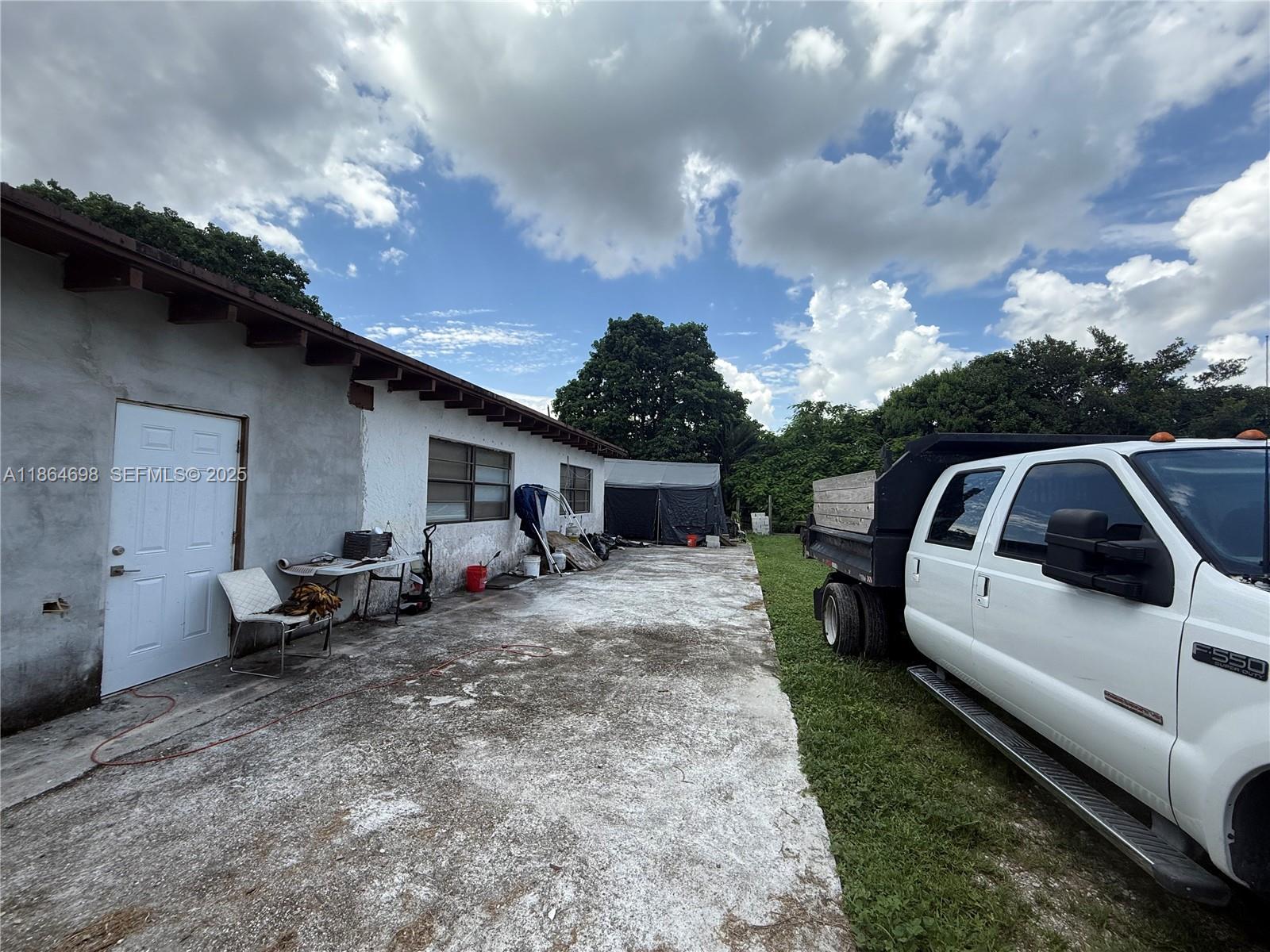 15765 Southwest 206th Avenue Miami, FL 33187 - Photo 14 of 57 a view of a house with backyard and entertaining space
