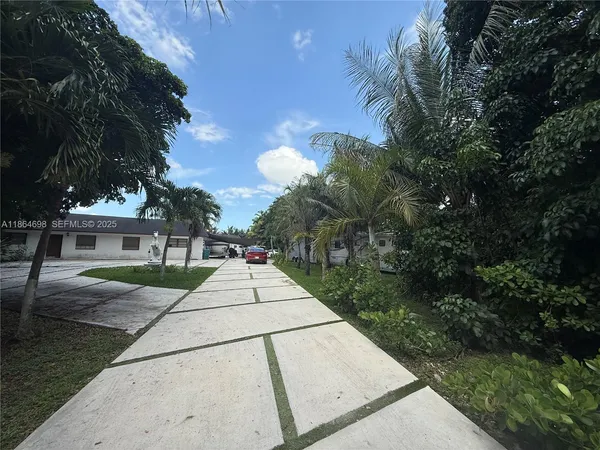 a pathway of a house with a yard