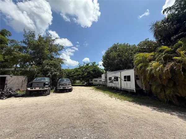 a view of a yard with large trees