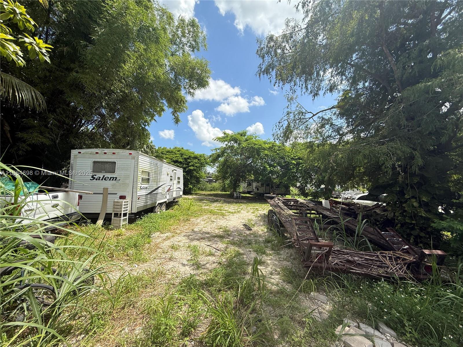 15765 Southwest 206th Avenue Miami, FL 33187 - Photo 26 of 57 a backyard of a house with yard and outdoor seating