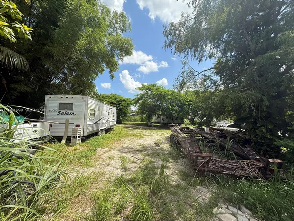 a view of a house with a yard covered in snow
