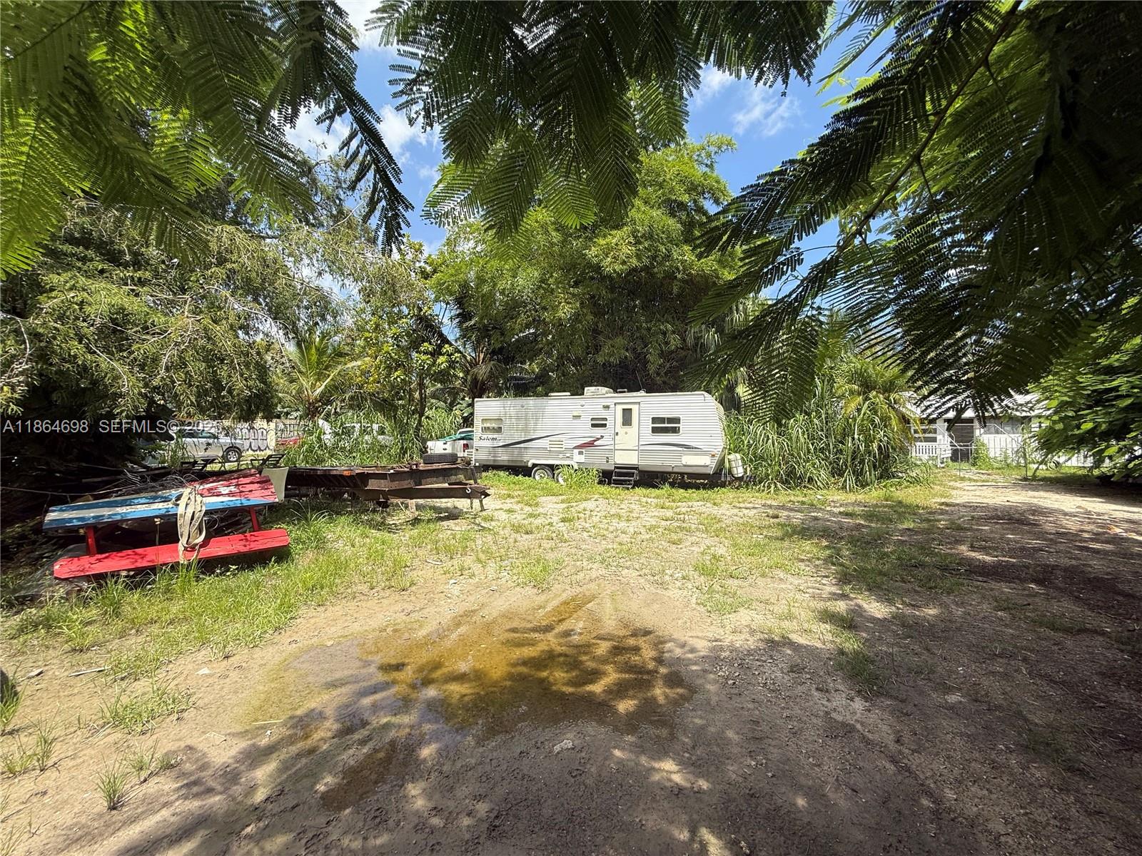 15765 Southwest 206th Avenue Miami, FL 33187 - Photo 27 of 57 a backyard of a house with table and chairs