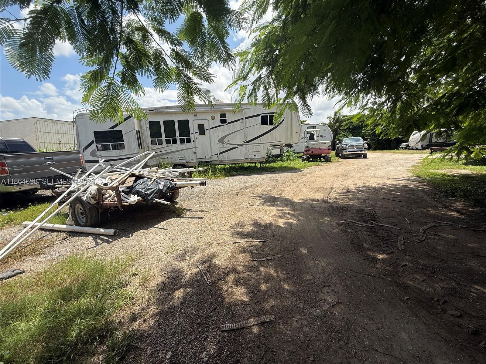 15765 Southwest 206th Avenue Miami, FL 33187 - Photo 30 of 57 a view of a house with a yard covered in snow
