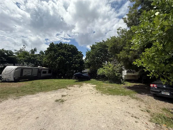a view of car parked in middle of forest