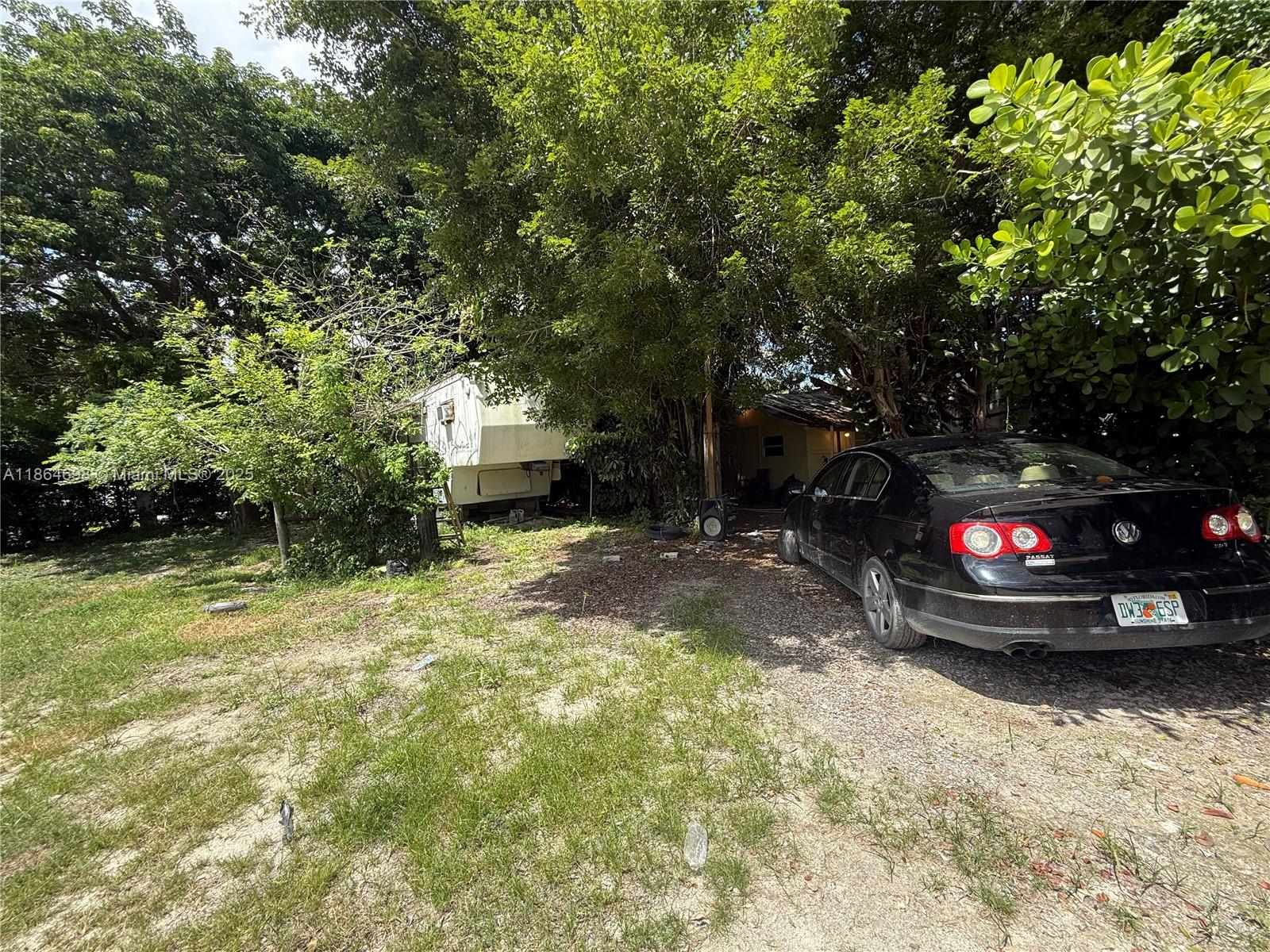 15765 Southwest 206th Avenue Miami, FL 33187 - Photo 36 of 57 a view of car parked in middle of forest
