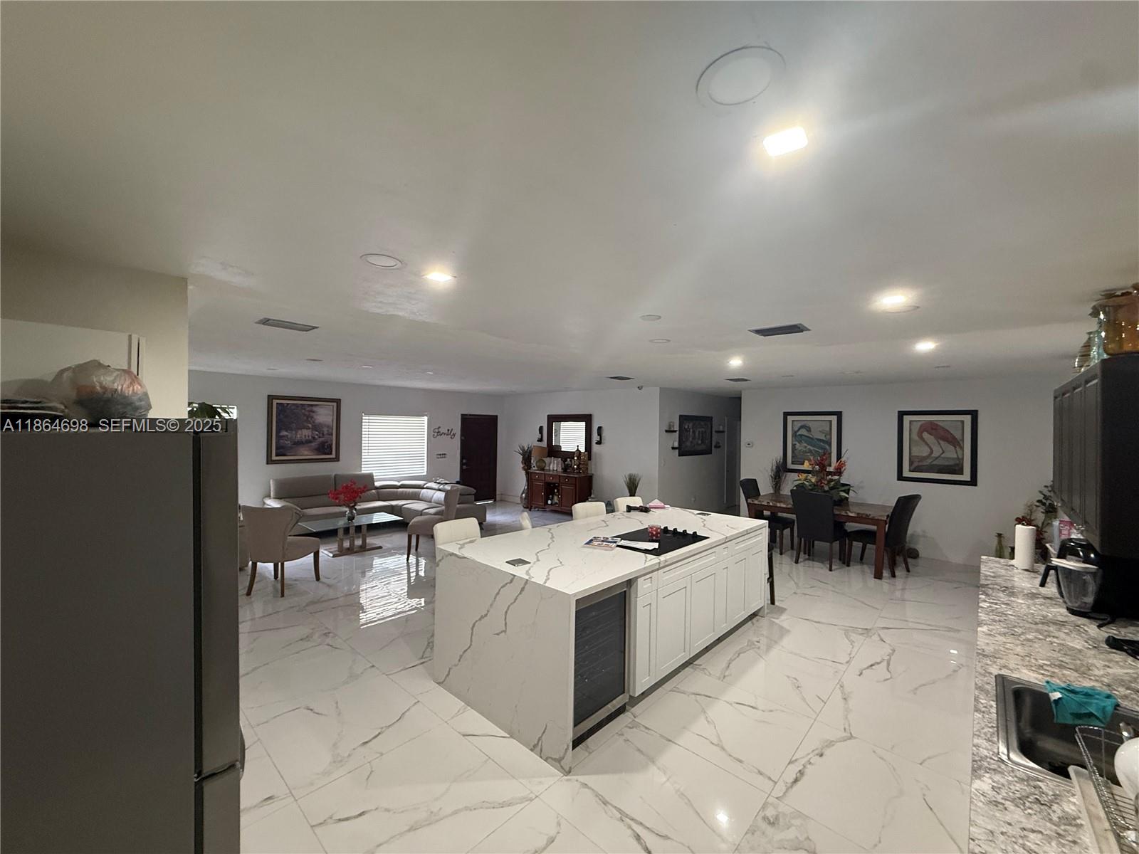 15765 Southwest 206th Avenue Miami, FL 33187 - Photo 43 of 57 a living room with furniture a flat screen tv and a table