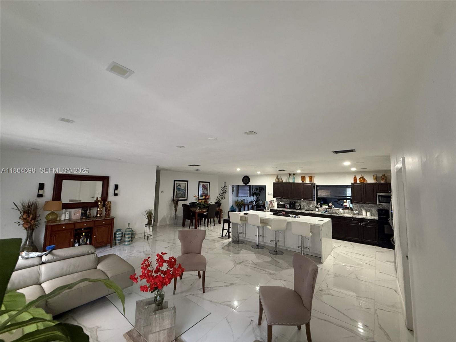 15765 Southwest 206th Avenue Miami, FL 33187 - Photo 44 of 57 a living room with furniture and kitchen view