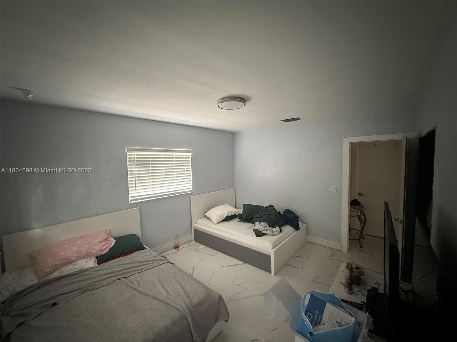 15765 Southwest 206th Avenue Miami, FL 33187 - Photo 53 of 57 a bedroom with a bed and a window