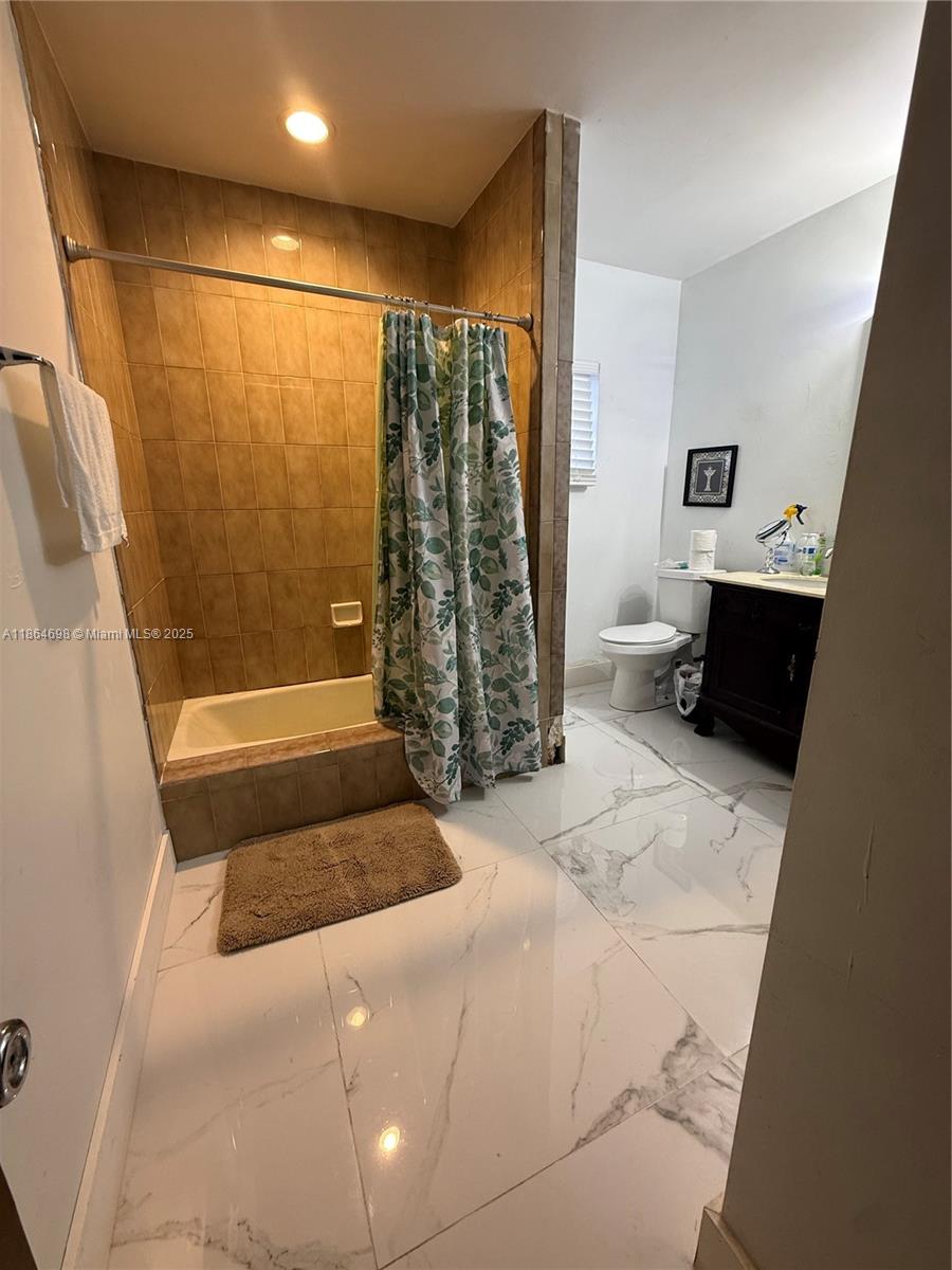 15765 Southwest 206th Avenue Miami, FL 33187 - Photo 54 of 57 a bathroom with a bathtub and a shower