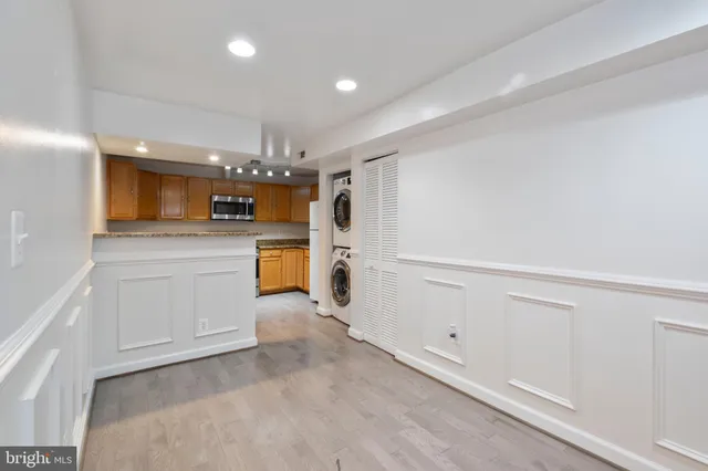 a view of a kitchen with a sink dishwasher stove and cabinets