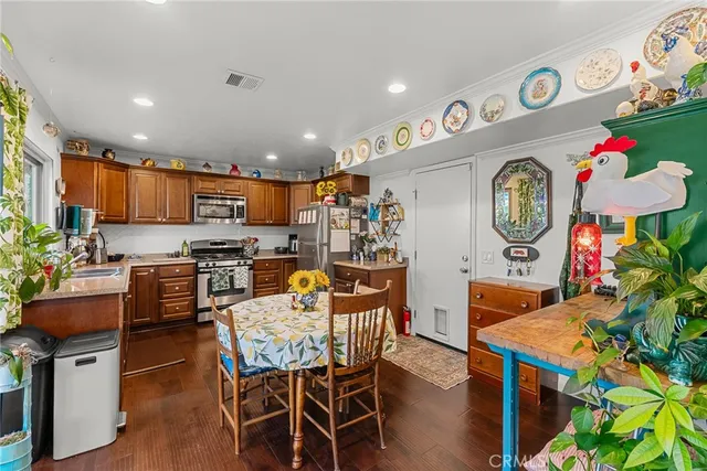an entryway with wooden floor and a plant